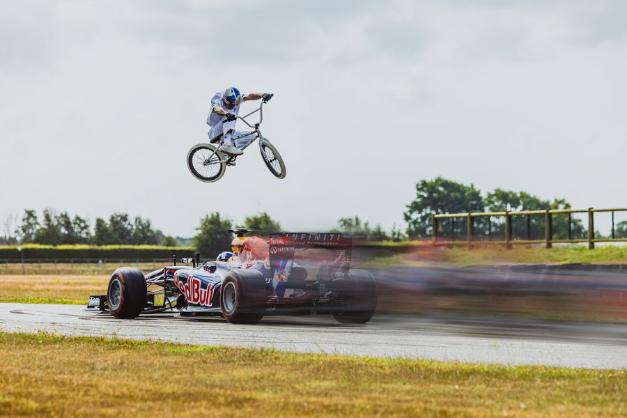 BMX legend Kriss Kyle jumps over an oncoming Formula 1 car, video